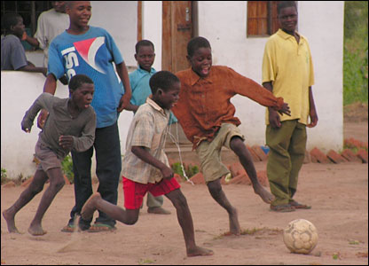 Children Playing Football In The Park