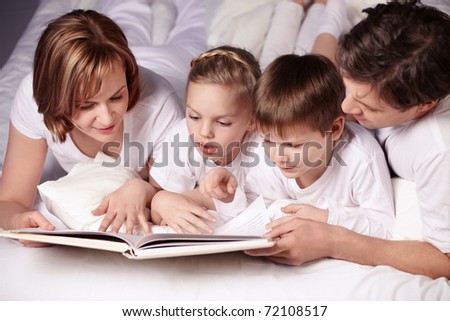 Children Reading Books With Parents