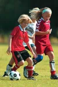 Young Children Playing Football